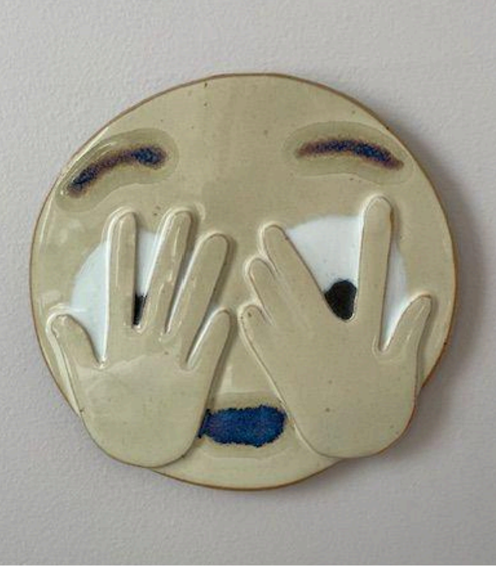 Hiding through fingers claymoji